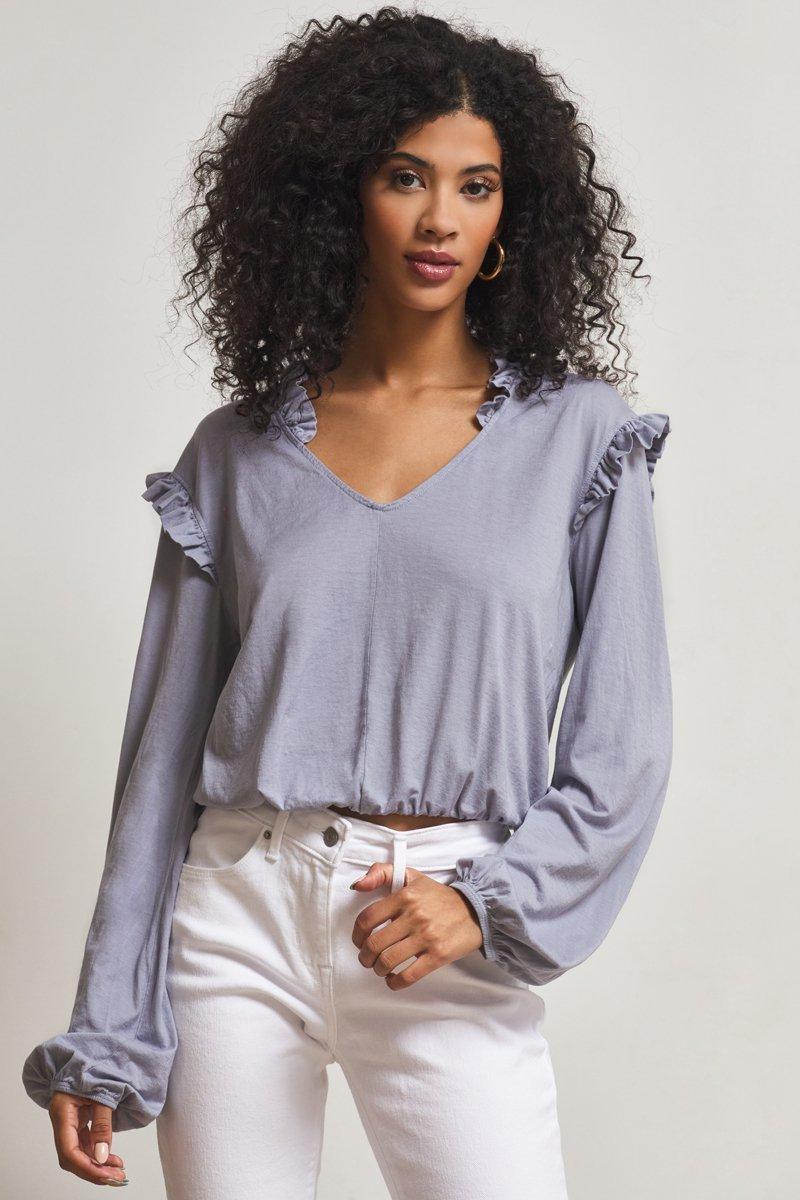 light blue top with ruffles on shoulder